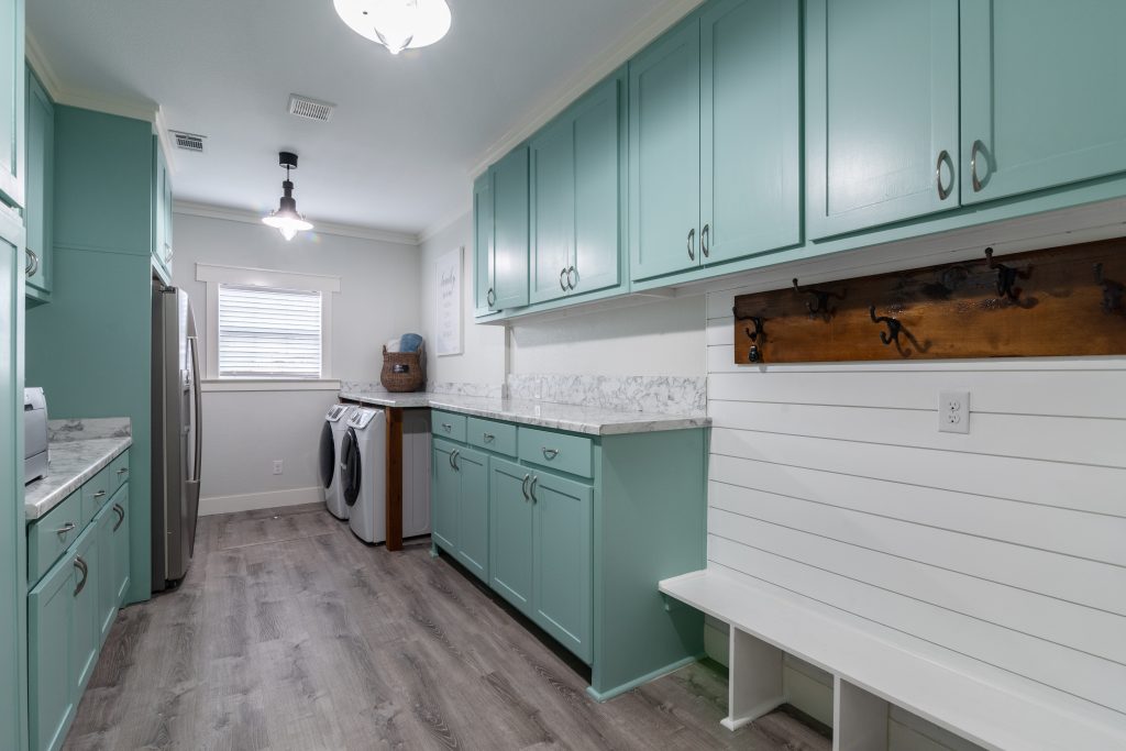 Mint green and white laundry room with mudroom, counter space, oversized,